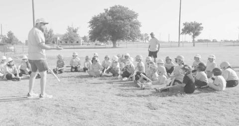 PAYING ATTENTION - The Levelland Youth Softball League held a summer camp at the Levelland City Park, June 23-24. The camp consisted of covering all the fundamentals with the game of softball and working on several drills to better their skills. Pictured is Youth League President Jacob Tucker speaking to the kids in attendance and instructors on what the camp covered and the importance of all the drills. (Staff Photo by Aalijah Soliz.)