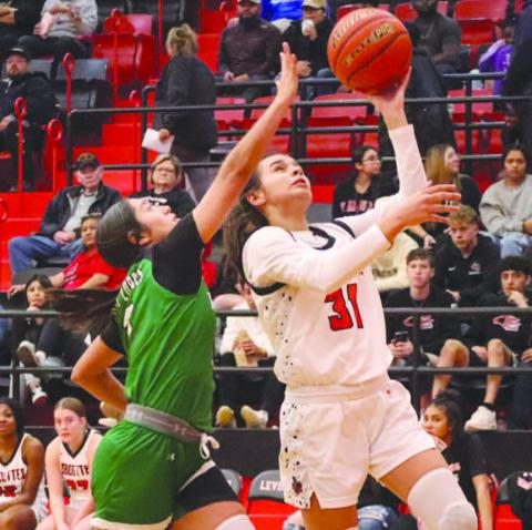 Levelland Loboette Leilani Sanchez layed the ball up through contact during the teams contest against the Monahans Lady Loboes. (Staff photo by Aalijah Soliz)