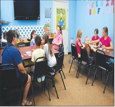 BOARD GAMES INDOORS – Pictured are kids having fun playing classic board games on Wednesday. The library’s summer reading activity featured Sorry, Connect 4, Chutes and Ladders, Candyland and more. (Staff photo by Ada Niederhauser)