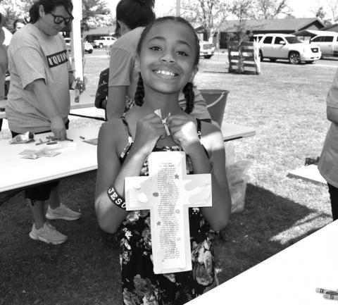 VBS FUN - Oasis Church in Levelland held vacation bible school at the Kaufman Park on Wednesday named Gods Rock-Solid Truth In A World Of Shifting Sand. The group had children participate in games, craft’s, dancing, snacks all structured around Bible school teachings. Pictured is Sophia Taylor with her finished footprint cross craft. (Staff photo by Emily Campos)