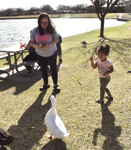 FEEDING THE DUCKS - On Wednesday at Brashear Lake Park little Emma was feeding the ducks and enjoying time with mom the ducks and the weather. They were enjoying Sping Break and the Spring like weather. Pictured is Mom Melinda Stofel and daughter Emma Stofel. (Staff photo by Emily Campos)