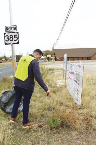 PICKING UP TRASH-- Keep Levelland Beautiful hosted a massive clean up this Saturday. Volunteers worked along Hwy. 114 cleaning up litter. (Staff photo by Shelby Radford)