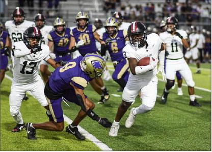 EVADE THE DEFENSE – Sophomore running back Noah Martin evades the defender as he rushes the football during a game against Dalhart this past Friday night at Memorial Stadium. (Staff photo by Jentezen Smith)