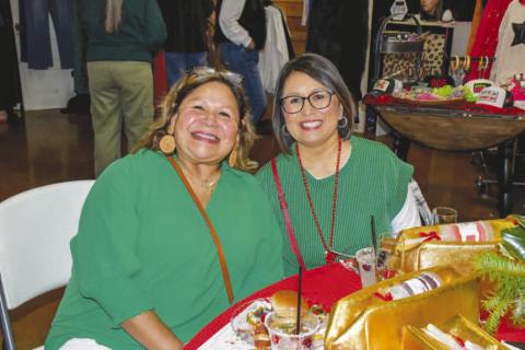 MATCHING – Chris Paredez and Veronica Lopez smiled together at their reserved Fa La La table near the vendor stands in Levelland at the Mallet Event Center and Arena, Dec. 12. (Staff photo by Evin Thomas)