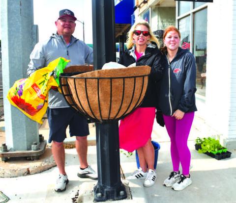 COMMUNITY PLANTING DAY - On Saturday, the Levelland Main Street Program held their annual Community Planting Day event with volunteers picking a planter around the downtown area to adopt. Pictured is Matt, Breanna and Mattie Buxkemper. (Staff photo by Emily Campos)