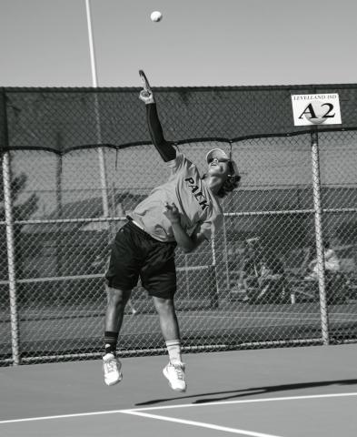 AT YOUR SERVICE - Diego Franco performs an overhand serve for the Levelland Tennis Pack during a match against Frenship Memorial this past Tuesday. The Pack would go on to lose 16-3. (Staff photo by Jentezen Smith)