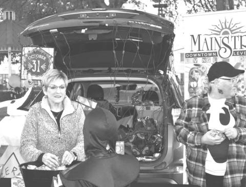 HALLOWEEN TIME - The Main Street Trunk-or-Treat event on Tuesday around the Levelland Court House was a success with many families and children attended in costumes. A great safe way for children to Trick -Or-Treat. Pictured is Levelland Mayor Barbra Pinner handing out candy to the community. (Staff Photo by Emily Campos)