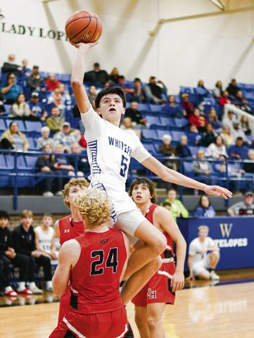 GANDARA WITH THE FLOATER - Whiteface Antelope Ivaniel Gandara lays up a floater while trying to evade contact with a New Home defender during their game this past Tuesday night in Whiteface. Gandara would score 12 points in the loss. (Staff photo by Jentezen Smith)