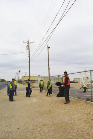 CLEANING UP-- Several volunteers worked Saturday picking up litter along Hwy. 114. (Staff photo by Shelby Radford)
