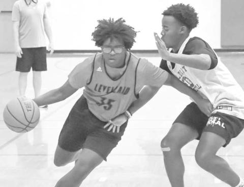 DRIVING- The Levelland Lobos hosted Littlefield and Canyon is exhibition matches Thursday at Levelland Middle School. Pictured driving to the basket is Lobo Tra Holland. (Staff Photo by Aalijah Soliz)