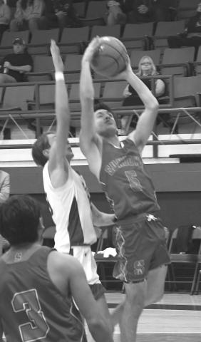 CONTESTED - Branson Sanders had 13 points to lead the Sundown Roughnecks in a 51-41 UIL high school boys’ basketball road win over Smyer Bobcats last Friday. The Roughnecks will be in the Littlefield Invitational Tournament December 28-30. (Photo by Jay Kelley)