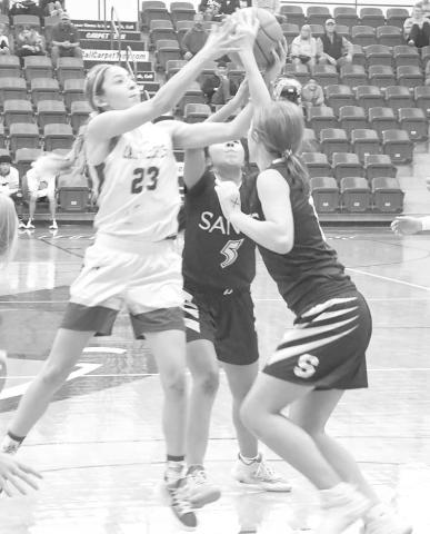 FIRST TIE- Whiteface’s Allison Martha fought for a rebound against two Sands Lady Stangs in a 41-38 overtime win over the Lady Stangs in the UIL Girls High School Class 1A Regional Quarterfinals at the Rip Griffin Center on the campus of Lubbock Christian University last Tuesday. Martha led the Lady Lopes with 12 points. (Photo Courtesy of Jay Kelley)