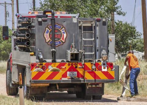 PIT FIRE - The Levelland Fire Department responded to a pit fire that had reached surrounding grass near Avenue X, Saturday. The department sent two grass trucks and a tanker to extinguish the fire. LFD Fire Chief Jay McKay reminded community members that outdoor burning can be dangerous with the extreme heat and low humidity. Hockley County is currently not under a burn ban. Community members are encouraged to reach out to the LFD to give notice of burning activity beforehand. (Staff photo by Jay Kelley)