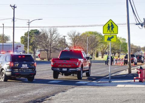DIVERTING TRAFFIC - On Wednesday morning, all southbound traffic on Avenue H was being diverted as Levelland Fire Department personnel and City of Levelland crew worked to clean leaking gasoline and hydraulic fluid that made its way on the road. Crews worked quickly to clean the spill as the fluids posed a threat of making it into the storm drain. (Staff photo by Emily Campos)