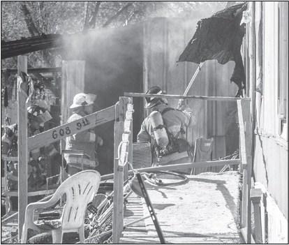 QUICK RESPONSE - The Levelland Fire Department responded to a structure fire in the 600 block of 9th Street Thursday morning. The Levelland Police Department provided traffic detail while fire crews extinguished the flames from a shed located behind the residence. (Staff photo by Dom Puente)