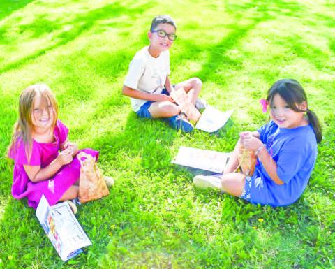 SUMMER PROGRAM FUN - The Hockley County Library Summer Program holds activities every summer for kids to participate in. A Chest Hunt was held Wednesday on the lawn of the Hockley County Courthouse where the children had to go to a different tree to pick up a clue that let them know where the treasure was located. Pictured is Blair Tomas, Cameron Castillo and Remi Ebarra. (Staff photo by Emily Campos)