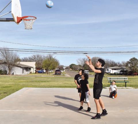OUTDOOR FUN - As the Spring season brings warmer weather, community members are encouraged to visit their local parks that span the City of Levelland. With over 200 acres of parkland, the City of Levelland has 13 parks in total and 14 playgrounds. Pictured are: Daniel Martinez, 15, Gage Gonzales, 11, Cade Cristan, 5, and Jaden Gonzalez, 8, enjoying their Monday during Spring Break playing basketball at Bartlett Park. (Staff photo by Emily Campos)