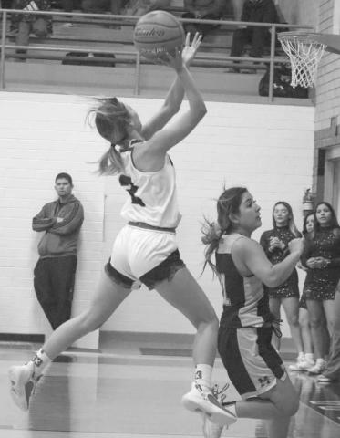 FASTBREAK - Whitharral Lady Panther Madi Chavez ran down the court on a fastbreak to lay the ball up over Morton defender Aerie Rodriguez this past Tuesday. (Staff photo by Aalijah Soliz)
