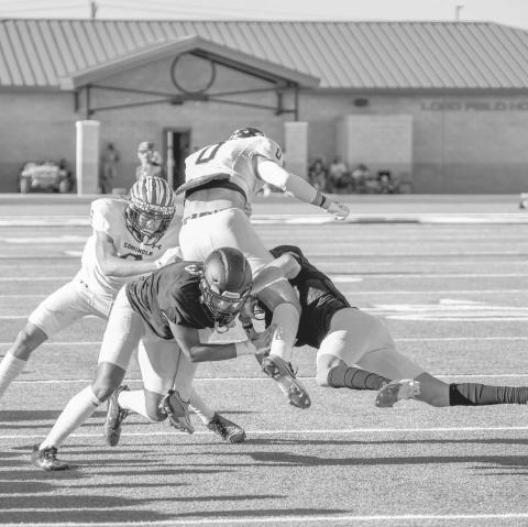 SECURE TACKLING - Two Levelland Lobos tackled a Seminole wide receiver in the open field this past Friday at home for their first scrimmage of the year. (Staff photo by Dom Puente)