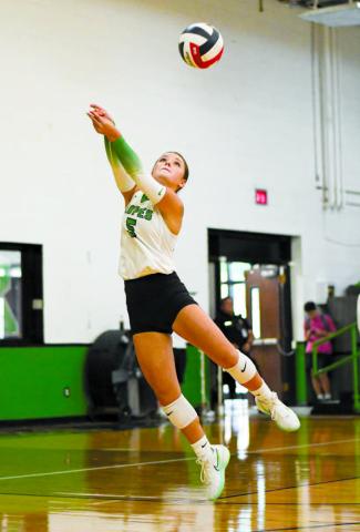 KEEP IT ALIVE – Braedyn Reyna twists and jumps to keep the volleyball in play during a game against Wellman Union this past Tuesday at the Ropes School. (Staff photo by Jentezen Smith)