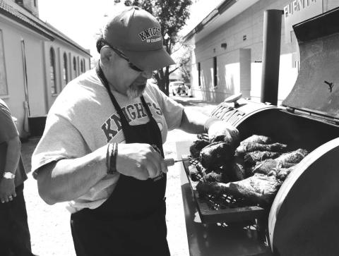 TURKEY LEGS- St. Michael’s Catholic Church had it’s 2024 Annual Jamaica on September 15. Pictured is Freddy Ruiz smoking turkey legs for the Jamica. (Photo courtesy of Emily Campos)