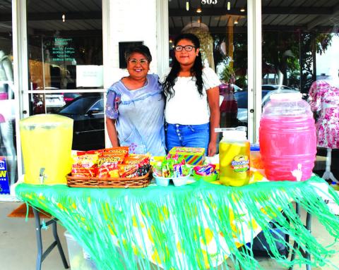 REFRESHING LEMONADE - The Levelland Main Street Program hosted a Lemonade Day event in downtown Levelland, Saturday. Pictured is Susie Ramirez and hr grandaughter Makenzy Mendoza. Lemonade Day was held in conjunction with Shop the Square and Community Planting Day. (Staff photo by Emily Campos)