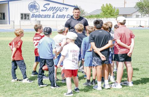 BUILDING FUTURE BOBCATS - Smyer Bobcats Athletic Director &amp; Head Football Coach Scott Funke instructs the Bobcat campers this past Tuesday during their football session at Smyer High School. Campers ranged from first to sixth grade. (Staff photo by Jentezen Smith)