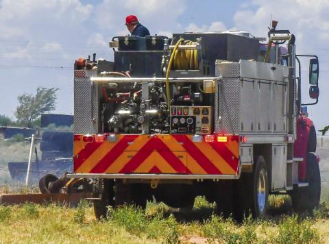PRIME GRASS FIRE CONDITIONS - With large amounts of fuel loading scattered around the West Texas area, extreme temperatures have increased the likelihood of grass fires starting. Low humidity and increased wind speeds are two key factors in grass fires and fire departments across the region are advising citizens to burn debris cautiously. Pictured is the Levelland Fire Department responding to an out of control pit fire that reached grass areas Saturday. (Staff photo by Jay Kelley)
