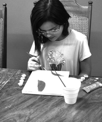 PAINTINGBYNUMBERS - At Capitol Elementary this past Tuesday Jazmin Marryfo enjoyed painting a beautiful piciture on canvaes. Jazmin is one of the Kid w/character award winner this nine weeks. (Staff photo by Emily Campos)