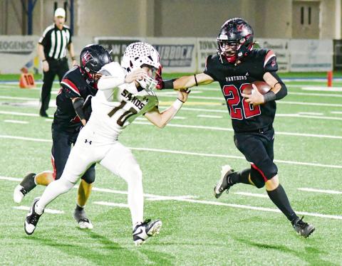 1A-2 DISTRICT 3 OFFENSIVE MVP - Whitharral senior running back Greg Johnson rushes the football and stiff arms a Sands defender during their playoff football game earlier this month in Lubbock. Johnson would end the season with 1,844 rushing yards and 37 touchdowns, which earned him the honor of 1A-2 District 3 Offensive MVP. (Staff photo by Jentezen Smith)