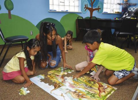 PUZZLING – Pictured are participants in Wednesday’s summer reading activity at the Hockley County Memorial Library. It was a smaller activity with board games and indoor fun. (Staff photo by Ada Niederhauser)