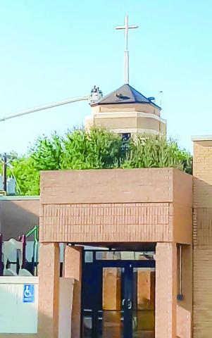 A NEW CHURCH STEEPLE - Pictured is a construction crew finishing the installation of a new church steeple at the First Baptist Church in Levelland located along Houston Street.