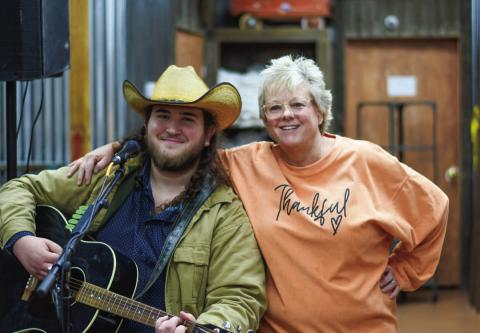 SINGING THE NIGHT AWAY - During the Main Street Ladies Night Out Event last Thursday, Austin James, a traveling singer from the New Braunfels area provided live music at Our Stuff located in downtown Levelland. Pictured along side James is Shanna Saunders who is the owner of the local business. (Staff photo by Myra Guerrero)