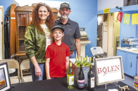 Tameisha, Gatlin and Rowdy Bolen smiled at the Bolen Vineyards table set up during Friday night’s Sip and Swirl event in Downtown Levelland. They served tacos to attendees along with their wine. (Staff photo by Evin Thomas)