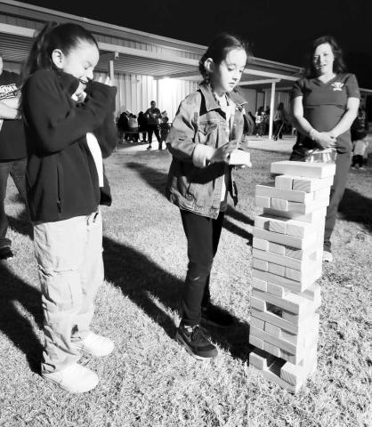 CAMP CAPITOL: Capitol Elementary held their Camp Capitol Parent Event last week. It was a time for families to learn together through different activites. Capitol Students and parents were able to participate in reading, tents, math, engineering, logic, design, art, games, the Book Fair, a campfire, and hotdogs. Pictured from left to right are students Viviana Garcia , Layla Carranza and thier mother Jenni Carranza.