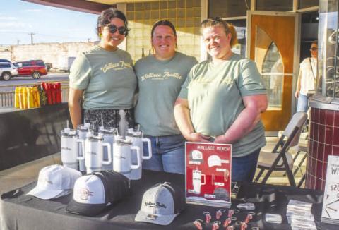 Arlette Silva, Jolenna Carter and Tina Wiiest smiled in front of Wallace Theater’s booth at Sip and Swirl on Friday evening, serving up wine, food and merchandise to attendees at the event. (Staff photo by Evin Thomas)