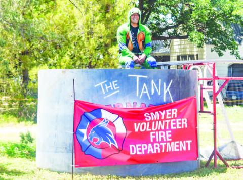 DUNK TANK - On Saturday, at the Smyer VFD Fundriser, the fire department set up a dunk tank. Pictured is Fire Fighter Joshua Flores dressed in a turtle outfit waiting for some one with a good aim to cool him off. There was also a cornhole tournament and a car show contest.(Staff photo by Emilly Campos)
