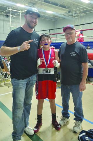 SKILLED BOXING - The Shark Attack Boxing team traveled to Searcy, Arkansas for the Regional Boxing Tournament Dec. 29-31, where Jeremy “Cade” Phelps won advancing to Independence, Missouri Jan. 30 to Feb. 1, for the National Silver Gloves. Pictured is Cade Phelps with Coaches Tray Phelps and Sharkey Lecroy. (Photo courtesy of Sharkey Lecroy)