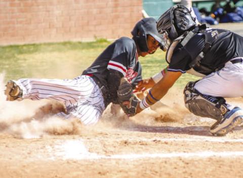 GET DOWN! - Pictured is Levelland Lobo Noah Tienda attempting to beat the tag from the Estacado catcher during Monday’s home game. Suffering a 9-4 loss against the Matadors, the Lobos used the quick turnaround to bounce back and earn their second district win of the season against the Big Spring Steers. Now 2-2 in district play, the Lobos went on the road to face off against the Snyder Tigers Friday. (Staff photo by Dom Puente)