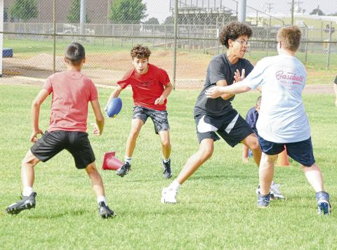 TACKLE PURSUIT DRILL - Antelope camper Noah Guillen rushes the football while Tabyus Castaneda blocks for him and Reed Crutcher and Kenston Lattimore look to make the two-touch tackle during a tackle pursuit drill at the Whiteface Sports Skills Camp this past Wednesday at Whiteface High School. (Staff photo by Jentezen Smith)