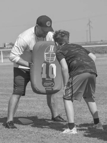 BLOCKING - Whitharral Head Coach Jeremy Holt and Panther Braxton Wecker were going over passing drills with hand placement this past Monday during the Whitharral Allj-Sports Camp. (Staff photo by Aalijah Soliz)