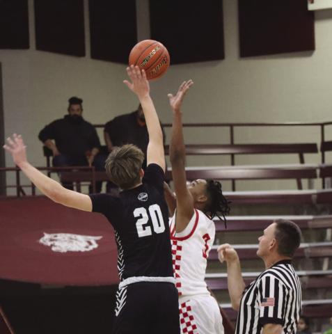 TIPOFF - Levelland Lobo Eryk Jones jumped in the tip off to get Levelland the first possession of the game against Bushland during the teams tournament in Littlefield. (Staff photo by Aalijah Soliz)