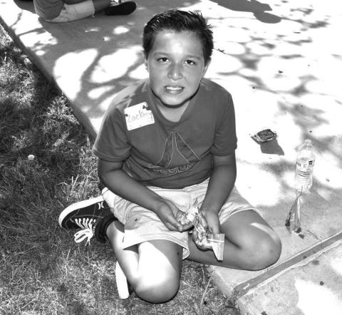 SNACK TIME - Oasis Vacation Bible School was held at the Kaufman Park on Wednesday. There were many activities for the kids to take part in. The event also included refreshments and snacks. Pictured is Zack Hernandez enjoying snack time. (Staff photo by Emily Campos)