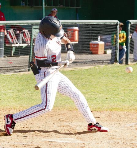 GET YOUR HANDS IN - Levelland Lobo Tobias Gavina gets his hands in to hit an inside pitch during their tournament game against Borger this past Friday at Levelland High School. (Staff photo by Eric Venkatesan)
