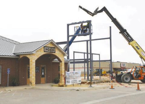 HCCU PROGRESS - Since the ribbon cutting and the ground breaking of what will become the new addition of the Hockley County Credit Union located along Clubview Drive, construction has been ongoing with a focus on dirtwork. Pictured is construction crews placing steel beams this past week next to the current credit union building. (Staff photo by Evin Thomas)