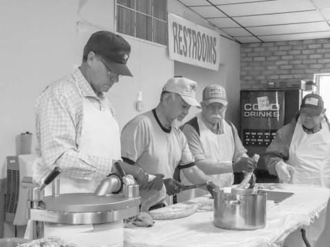 GROUP EFFORT - Pictured is David Albus, Henry Pompa and Dixon Moreland preparing the sausage for the 40th Annaul Sausage Lovers Festival which will be held Sunday, Feb. 16 at St. Michael Catholic Church. (Staff photo by Adriana Solis)