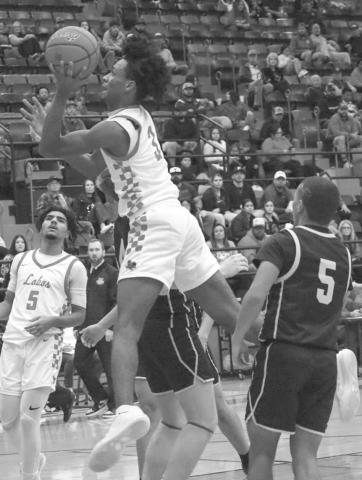 HIGH FLYING - Levelland Lobo Eryk Jones made the tough layup during the teams contest against the Snyder Tigers this past Friday in district basketball play. (Staff photo by Aalijah Soliz)