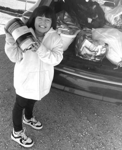 STAYING WARM- The Capital Elementary School second-grader raised money to make 100 care bags for the homeless last week. With alittle help from family and friends. Davenee Jaramillo in picture raised the money , brouhjt everyone togeather, and made a difference for many in these freezing weather.(Photo submitted by Cristal isaacks).