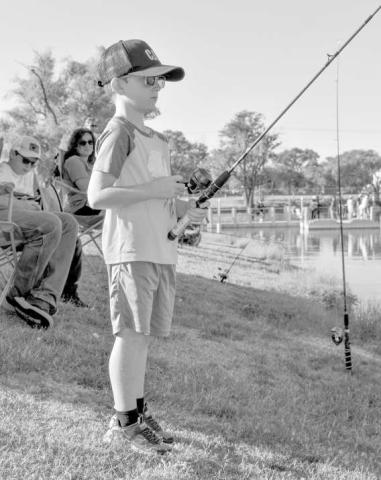 FISHING FUN - Pictured is Nash Jones who was focused on his line during Casting With Cops last Saturday at Lobo Lake. (Staff photo by Ada Niederhauser)