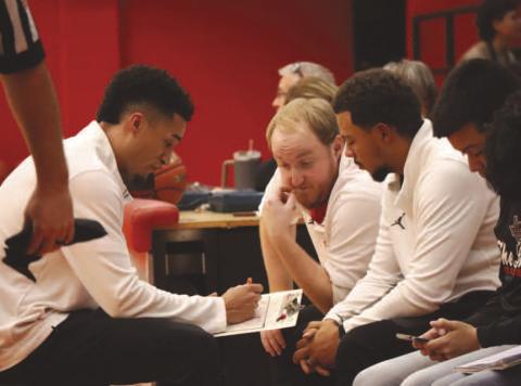 Levelland Lobo Head Basketball Coach Jordan Windholz and his coaching staff went over a few things they saw during the halftime break of their game against Jayton. (Staff photo by Aalijah Soliz)